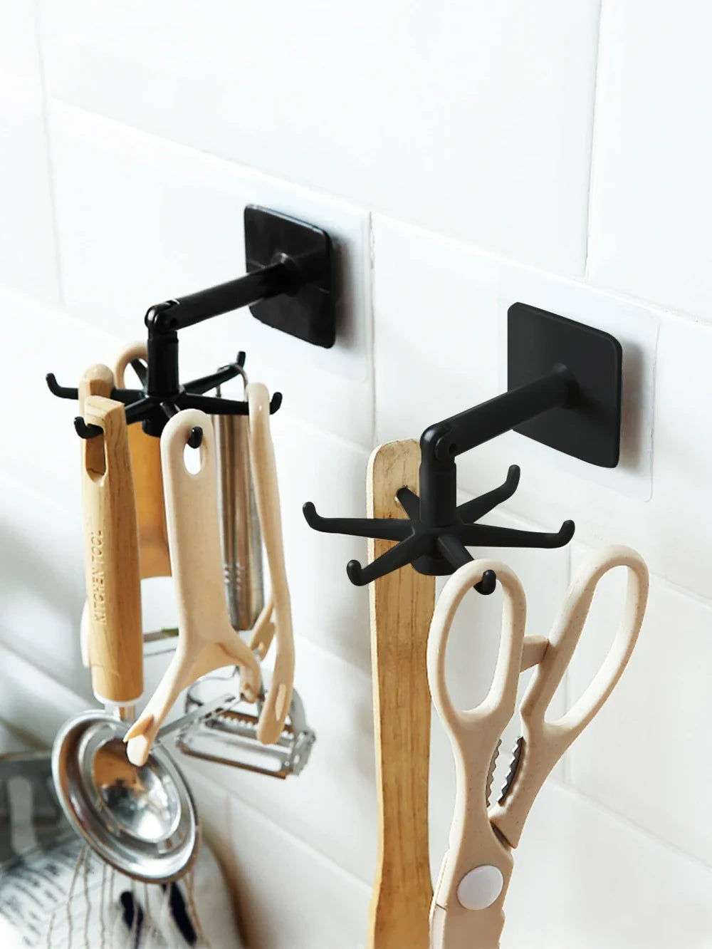 Wall mounted rotating spoon and spatula hanger holding kitchen utensils
