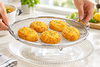 Basket on glass stand with golden food
