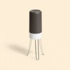 Hands-free automatic three-leg pan stirrer on a cream studio background