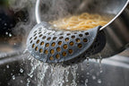 Clip-On Silicone Pot Strainer - Snap-On Pasta and Veggie Drainer - pasta draining close-up